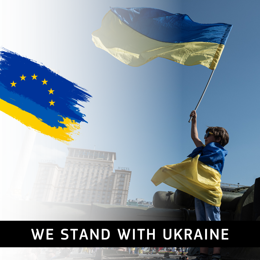 A visual showing a woman waving a Ukrainian flag. Next to her is a brushed version of the EU flag mixed wit the Ukrainian flag. At the bottom is the text: "We stand with Ukraine."